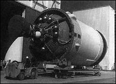 A new S-IVB stage rolls out of the production facility, on its way to firing test. The white sphere is the combination helium-hydrogen start tank for the J-2 engine; the other tank contain helium for pressurization