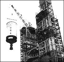 An S-IVB stage is hoisted into the Beta test stand in Sacramento for the acceptance firing test.