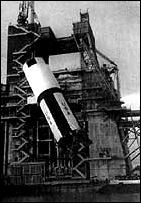 the completed stage is shipped to the Mississippi Test Facility and hoisted into the test stand (left) for static-firing tests before shipment to the Kennedy) Space Center where the total flight vehicle will be stacked, checked out, and launched
