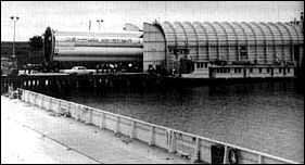 An S-IB stage is loaded aboard the barge Palaemon at Michoud.