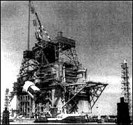 the 124-meter-tall test stand at the Mississippi Test Facility is hoisting the first operational S-IC first stage for the Saturn V into test position