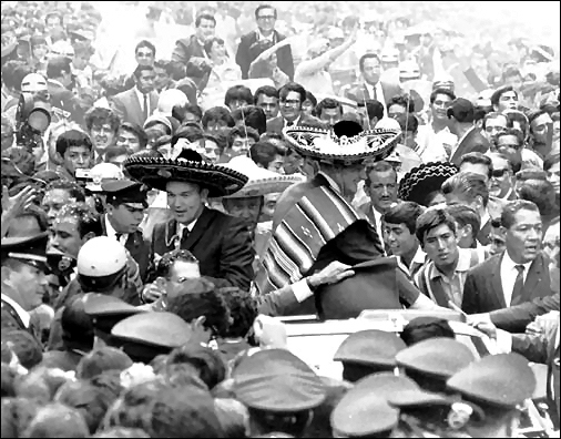 The Apollo 11 astronauts, wearing sombreros and ponchos, are swarmed by thousands as their motorcade is slowed by the enthusiastic crowd in Mexico City, their first stop on the Giantstep-Apollo 11 Presidential Goodwill Tour.