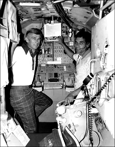 Apollo 17 mission commander Eugene A. Cernan, and lunar module pilot Dr. Harrison H. Schmitt at right, familiarize themselves with equipment used in the lunar module while undergoing prelaunch training in the lunar module simulator at the Flight Crew Training Building at the Kennedy Space Center on October 27, 1972
