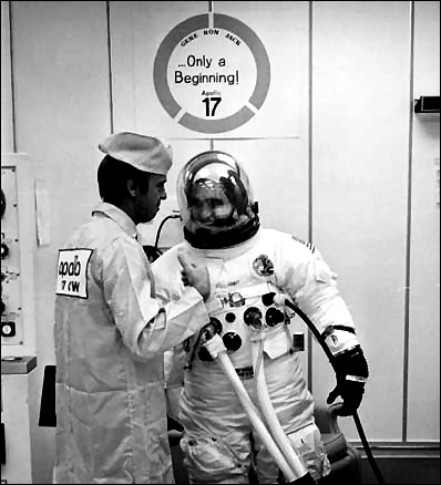 Harrison Schmitt shares a moment of relaxation with astronaut Alan Shepard during prelaunch suiting operations at the Kennedy Space Center.